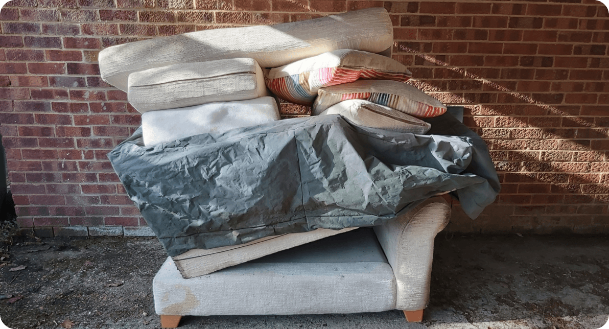 sofa and armchair with cushions stacked