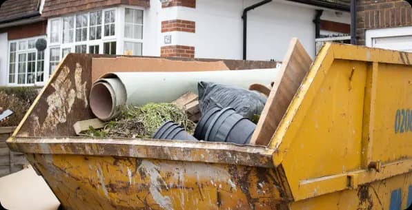 Skip outside a residence with waste inside